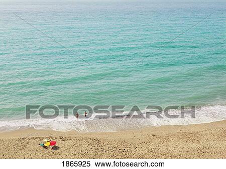 Stock Photography - Couple On Empty Beach; Nerja, Costa Del Sol, Malaga, Spain. Fotosearch