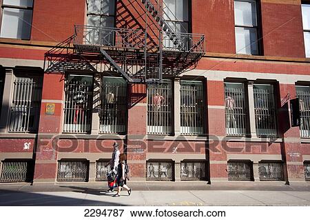 Stock Photo - Couple Passing By An Apartments Building In Tribeca, Manhattan, New York, Usa. Fotosearch