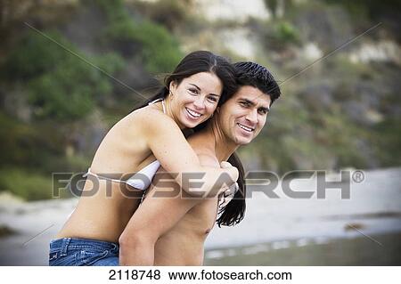 Couple Piggybacking On A Beach; Encinitas California Usa View Large Photo Image Stock Photo - Couple Piggybacking On A Beach; Encinitas California Usa. Fotosearch