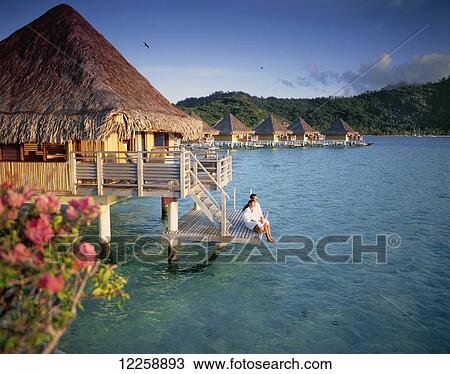 Couple relaxing at an overwater bungalow; Bora Bora View Large Photo Image Stock Image - Couple relaxing at an overwater bungalow; Bora Bora. Fotosearch