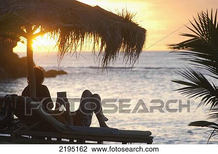 Couple relaxing at dusk on beach of La Luna Hotel; Grenada View Large Photo Image Stock Image - Couple relaxing at dusk on beach of La Luna Hotel; Grenada. Fotosearch