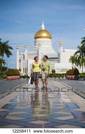 Couple shopping with Sultan Omar Ali Saifuddien Mosque in the background; Bandar Seri Begawan, Brunei View Large Photo Image Stock Image - Couple shopping with Sultan Omar Ali Saifuddien Mosque in the background; Bandar Seri Begawan, Brunei. Fotosearch