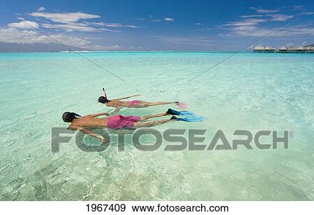 Couple Snorkeling In Tropical Ocean Water. View Large Photo Image Stock Photo - Couple Snorkeling In Tropical Ocean Water.. Fotosearch