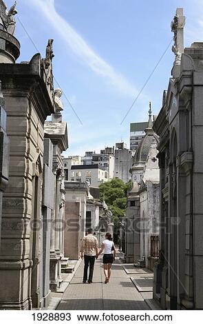 Stock Image - Couple Visiting Recoleta Cemetery. Fotosearch