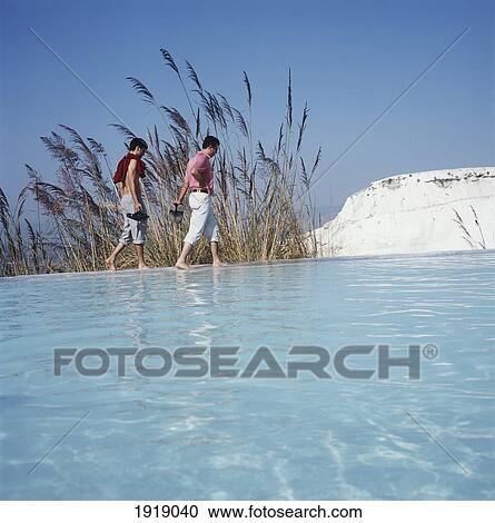 Stock Image - Couple Walk Beside The Water, Travertine Pools. Fotosearch