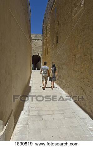 Couple Walking Along Narrow Passage, Rear View View Large Photo Image Stock Photo - Couple Walking Along Narrow Passage, Rear View. Fotosearch