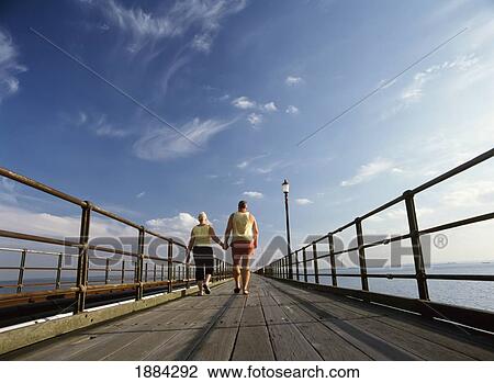 Couple Walking Down Pier View Large Photo Image Stock Image - Couple Walking Down Pier. Fotosearch