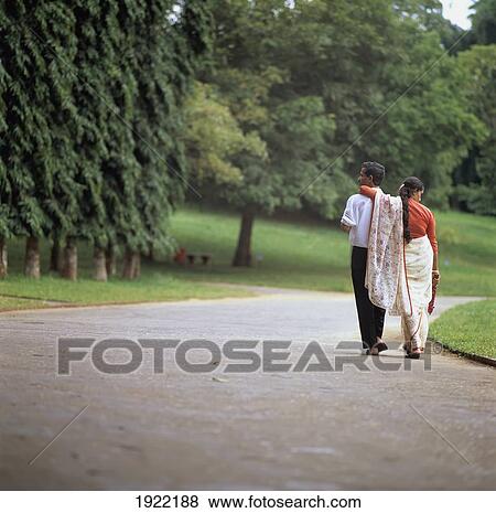 Stock Photo - Couple Walking Down The Street. Fotosearch