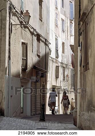 Stock Photography - Couple Walking Throught The Streets Of Bonifacio, Corsica, France.. Fotosearch