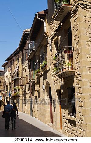 Picture - Couple Walking Together On Street In The Medieval Village Of Laguardia, Basque Country, Spain. Fotosearch