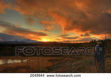 Couple Watching Sunset Over Dawson Peaks, Teslin, Yukon View Large Photo Image Picture - Couple Watching Sunset Over Dawson Peaks, Teslin, Yukon. Fotosearch
