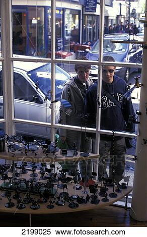 Stock Photography - Couple Window Shopping At Metal Guru Interiors, Brighton, East Sussex, England. Fotosearch