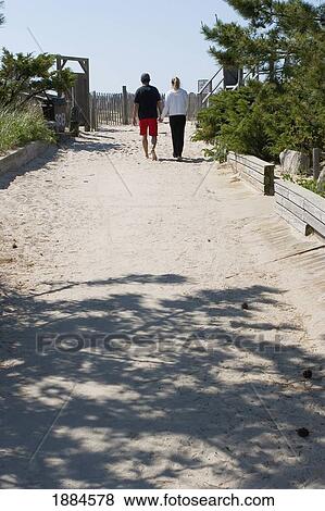 Couple Wlakign Onto Ocean Beach View Large Photo Image Stock Photo - Couple Wlakign Onto Ocean Beach. Fotosearch