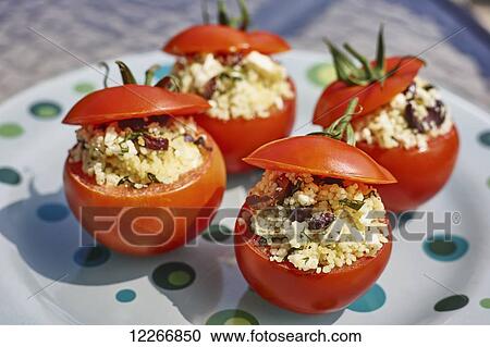 Couscous with herbs, olives, and feta cheese stuffed tomato appetizer View Large Photo Image Stock Image - Couscous with herbs, olives, and feta cheese stuffed tomato appetizer. Fotosearch