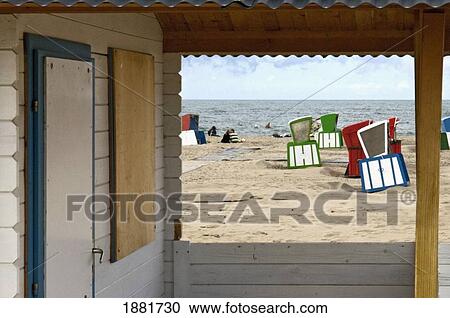 Stock Image - Covered Beach Chairs And Beach Hut On Beach. Fotosearch