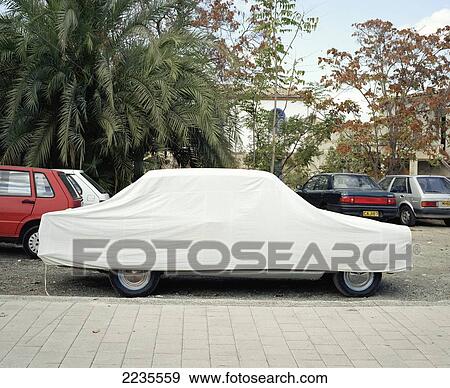 Covered car, in city car park, Nicosia, Cyprus. View Large Photo Image Stock Photo - Covered car, in city car park, Nicosia, Cyprus.. Fotosearch