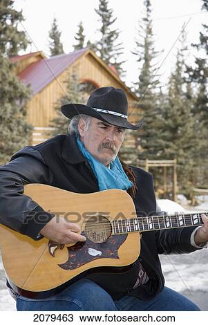 Cowboy Playing Guitar Outdoors In Winter; Bragg Creek Alberta Canada View Large Photo Image Stock Image - Cowboy Playing Guitar Outdoors In Winter; Bragg Creek Alberta Canada. Fotosearch