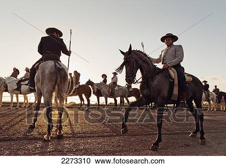 Stock Image - Cowboys on horses; tarifa cadiz andalusia spain. Fotosearch