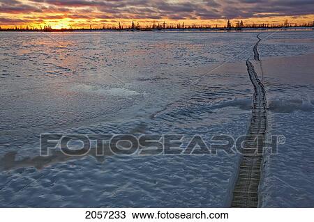 Crack In The Ice Of Dymond Lake, Near Churchill, Manitoba. Sunset Shot. View Large Photo Image Stock Image - Crack In The Ice Of Dymond Lake, Near Churchill, Manitoba. Sunset Shot.. Fotosearch