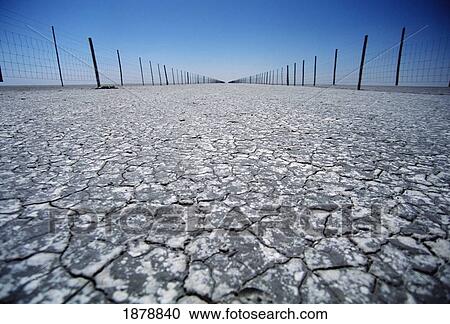 Cracked Ground And Fences In Desert View Large Photo Image Stock Image - Cracked Ground And Fences In Desert. Fotosearch