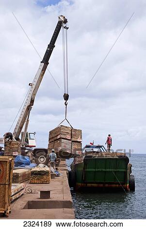 Stock Photo - Crane loads crates on to freighter destined for Valparaiso; Easter Island, Chile. Fotosearch