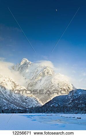 Crescent moon above snow covered Chugach Mountains and the frozen Eagle River, Chugach State Park, Southcentral Alaska, Winter. View Large Photo Image Stock Image - Crescent moon above snow covered Chugach Mountains and the frozen Eagle River, Chugach State Park, Southcentral Alaska, Winter.. Fotosearch