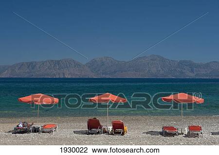 Crete, Gulf of Mirabello; Agios Nikolaos, Sun Shades on Kitro Platia Beach View Large Photo Image Stock Image - Crete, Gulf of Mirabello; Agios Nikolaos, Sun Shades on Kitro Platia Beach. Fotosearch
