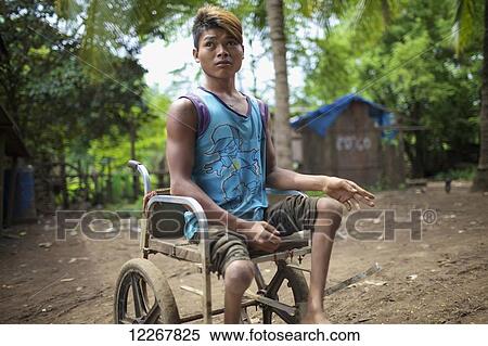 Crippled young man in a wheelchair; Mondulkiri, Cambodia View Large Photo Image Stock Photography - Crippled young man in a wheelchair; Mondulkiri, Cambodia. Fotosearch