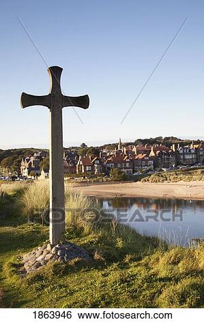 Stock Photograph - Cross On A Hill Overlooking Town; Alnmouth, Northumberland, England. Fotosearch