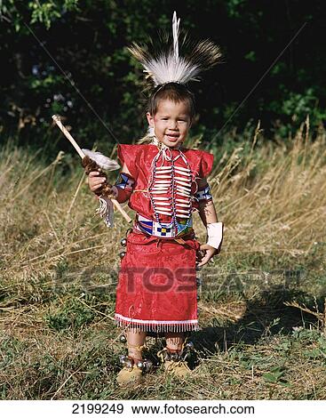 Crow Boy In Traditional Regalia Getting Ready To Take Part In The Morning Parade During Annual Crow Fair (August), The Largest Native American Festival In The Usa. The Crow (Apsaaloke, Apsaroke Or Absaroke) Live In The Crow Reservation (Montana, Usa). View Large Photo Image Stock Photo - Crow Boy In Traditional Regalia Getting Ready To Take Part In The Morning Parade During Annual Crow Fair (August), The Largest Native American Festival In The Usa. The Crow (Apsaaloke, Apsaroke Or Absaroke) Live In The Crow Reservation (Montana, Usa).. Fotosearch