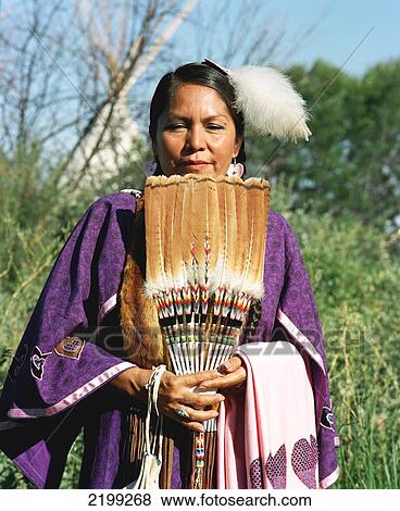 Stock Photo - Crow Woman In Traditional Regalia Waiting To Take Part In The Pow-Wow During Annual Crow Fair (August), The Largest Native American Festival In The Usa. The Crow (Apsaaloke, Apsaroke Or Absaroke) Live In The Crow Reservation (Montana, Usa).. Fotosearch