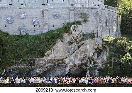 Stock Photo - Crowd Gathered At The Sacred Grotto Sanctuary Of Our Lady Of Lourdes; Lourdes Hautes-Pyrenees France. Fotosearch