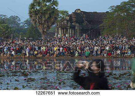 Crowd of tourists watching the last sunset of 2014 at Angkor Wat; Siem Reap, Cambodia View Large Photo Image Stock Image - Crowd of tourists watching the last sunset of 2014 at Angkor Wat; Siem Reap, Cambodia. Fotosearch