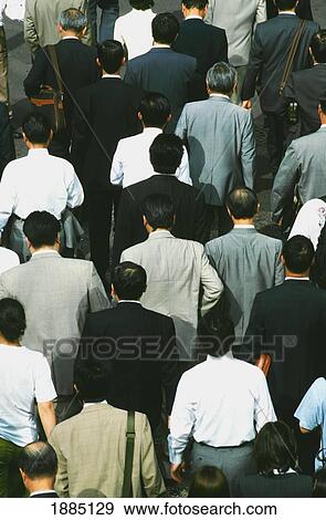 Stock Photo - Crowds Of Businessmen Walking On The Streets Of Tokyo. Fotosearch