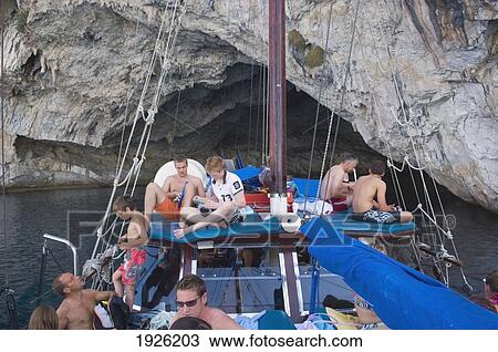 Cruise Boat Near Rocky Cave In Ionian Sea, Lefkas, Greece View Large Photo Image Stock Image - Cruise Boat Near Rocky Cave In Ionian Sea, Lefkas, Greece. Fotosearch