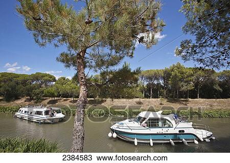 Cruise boats on the Canal du Midi; France View Large Photo Image Stock Image - Cruise boats on the Canal du Midi; France. Fotosearch