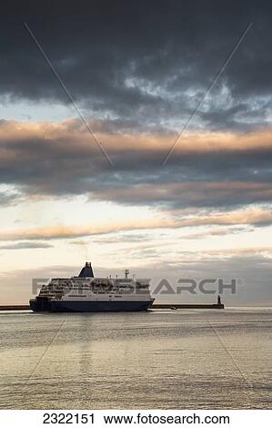 Stock Image - Cruise ship along pier at sunset; South Shields, Tyne and Wear, England, UK. Fotosearch