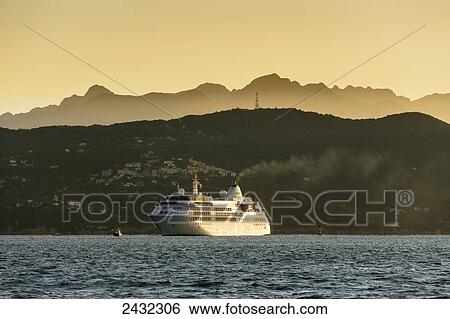 Stock Photograph - Cruise ship at sunrise; Porto Venere, Liguria, Italy. Fotosearch