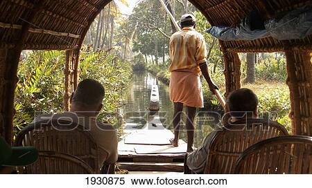 Stock Photography - Crusing through the backwater canals in Alappuzha, Kerala, India., Alappuzha, Kerala, India.. Fotosearch