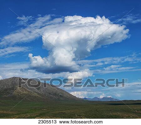 Stock Image - Cumulus Clouds Forming Over The Dempster Highway; Yukon Canada. Fotosearch
