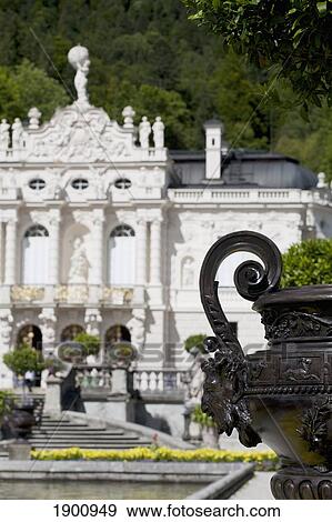 Stock Photo - Curled Handle With A Face On A Vase With A White Castle In The Background; Linderhof, Germany. Fotosearch