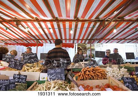 Stock Image - Customer at the Food market at La Rochelle, Food market at La Rochelle. Poitou-Charentes region of France.. Fotosearch