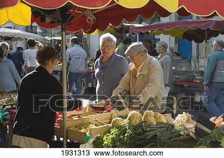 Customers buying vegetables at yhe markets of Rochefort, Charente-Maritime department of the Poitou-Charentes region of France. View Large Photo Image Stock Image - Customers buying vegetables at yhe markets of Rochefort, Charente-Maritime department of the Poitou-Charentes region of France.. Fotosearch
