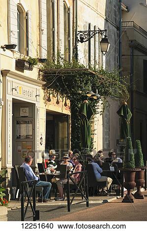 Customers sitting on an outdoor patio; Arles, Provence-Alpes-Cote D'Azur, Bouches-Du-Rhone, France View Large Photo Image Stock Image - Customers sitting on an outdoor patio; Arles, Provence-Alpes-Cote D'Azur, Bouches-Du-Rhone, France. Fotosearch