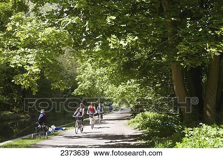 Stock Photo - Cycling along path next to Kennet and Avon Canal; Wiltshire, England. Fotosearch