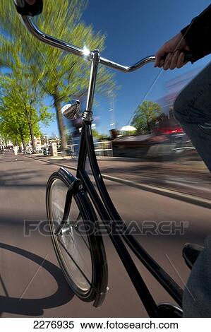 Stock Photography - Cycling down cycle path; Amsterdam, Holland. Fotosearch