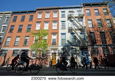 Stock Photography - Cycling In Front Of Some Apartments Buildings In The West Village, Manhattan, New York, Usa. Fotosearch