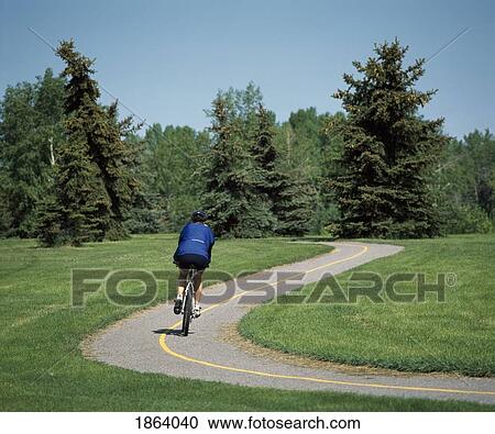 Stock Image - Cycling On A Pathway, North Glenmore Park, Calgary, Alberta, Canada. Fotosearch