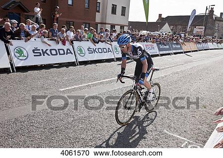 Stock Image - Cyclist finishing this stage of the Tour of Britain cycling race; Wells, Somerset, England. Fotosearch