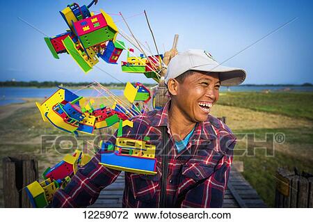 Stock Image - Cyclist on U Bein Bridge; Mandalay, Myanmar. Fotosearch